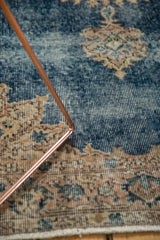 Distressed Sparta rug with faded sky blue field, antique ivory border pattern, and visible foundation wear.