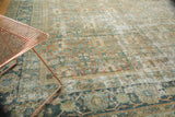 Distressed vintage Mahal carpet featuring worn Herati patterns in pale terra cotta and teal.