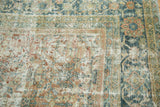 Distressed Vintage Mahal carpet's worn foundation, faded terra cotta, and teal floral patterns.