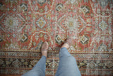 Distressed vintage Mahal rug: worn terra cotta field with muted floral motifs and exposed foundation.
