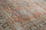 Distressed Persian Mahal carpet: worn terra cotta field, faded floral motifs, visible foundation.