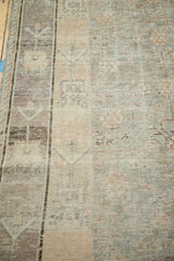 Distressed vintage Khotan carpet texture, featuring geometric vinery and soft color abrashes.