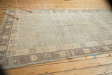 Distressed vintage Khotan carpet, showing faded pale blush, oxidized silver, and ivory tones.