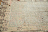 Distressed vintage Khotan rug's pale silver and blush geometric vinery with soft abrashes.