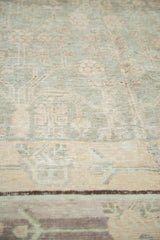 Textured pile of vintage distressed Khotan carpet, revealing geometric vinery in pale silver and blush.