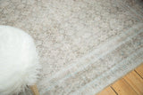 Textured distressed herati motif with etched pale blue and ivory tones on a vintage Birjand rug.