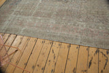 Faded pale blush rose border and evenly worn pile texture on the distressed Sivas carpet.