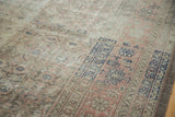 Distressed texture and faded blue border motifs of the vintage Sivas carpet.