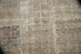 Distressed texture of the vintage Sivas carpet, featuring faded Herati motif in blush and silver.