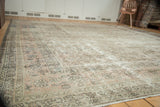 Distressed Sivas carpet corner revealing faded Herati motif with silver and pale blush tones.