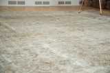 Distressed texture and faded Herati pattern in muted silver, ivory, and blush tones.