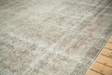 Vintage distressed Sivas carpet border corner, with faded floral motifs in pale blush and ivory.