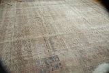 Distressed Sivas rug surface with soft Herati motif and muted silver, blush rose tones.