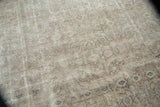 Distressed vintage Sivas carpet texture showcasing faded Herati pattern in silver, blush, and ivory tones.