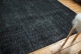Charcoal black and indigo distressed Sivas carpet with fine weave and faint foundation.