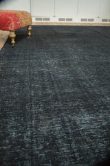 Distressed charcoal black overdyed Sivas carpet, displaying textured wear and faint foundation.