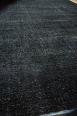 Distressed charcoal indigo pile of vintage Sivas carpet showing fine texture and even wear.