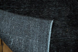 Detail of hand-knotted Sivas foundation and textured charcoal black distressed pile.
