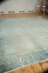 Distressed antique Peking carpet, showing worn pile, visible foundation, sea foam blue and ivory.