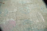 Distressed texture of the antique Peking rug, revealing foundation with bubblegum pink and sea foam blue.