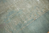 Distressed texture of Peking carpet, showing worn pile in sea foam blue and platinum tones.