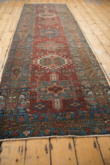 Distressed low pile Karaja runner, featuring burgundy and teal geometric hook motifs.