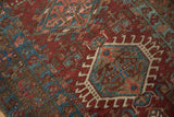 Distressed Karaja rug runner with burgundy, teal, ivory hook and latch motifs.