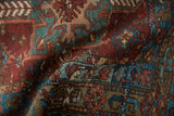 Distressed Karaja rug low pile, with burgundy, teal, and bronze geometric motifs.