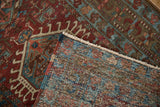 Close-up of distressed Karaja runner's low pile, woven back, and fringed edge.