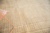 Mir Sarouk carpet detail featuring intricate boteh pattern in sand, pale blue, and light foundation wear.