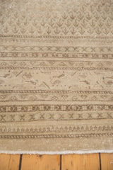 Intricate patterns and low pile of a vintage Mir Sarouk carpet in sand and beige tones.
