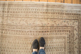 Mir Sarouk carpet detail: faded boteh pattern, neutral tones, even wear exposing foundation.