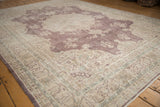 Distressed plum medallion and light floral patterns on a vintage Sivas rug.