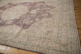 Distressed vintage Sivas carpet showing plum and ivory floral field with subtle blue accents and wear.