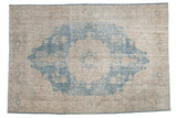 Distressed Turkish Sparta rug, sky blue medallion, antique ivory field, visible texture, 7' x 10'4