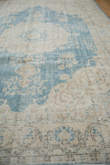 Distressed sky blue and ivory pattern showing wear to knot heads and foundation.