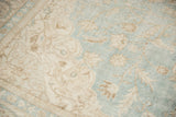 Time-softened sea foam green and antique ivory floral texture of the distressed Sivas rug.