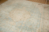 Distressed pile of vintage Sivas carpet, displaying sea foam green and ivory European floral design.