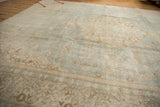 Worn sea foam green and antique ivory European floral pile of a distressed Sivas carpet.