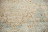 Textured pile of vintage Sivas carpet showing mostly even wear and European floral motifs in sea foam and ivory.
