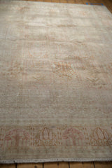 Distressed vintage Kashmir silk carpet with even wear to knot heads and faded multi-paneled patterns.