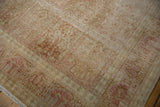 Vintage distressed Kashmir silk rug showing mostly even wear and faded pink patterns.