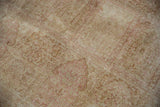 Faded ivory and pale pink multi-paneled design on a distressed Kashmir silk rug.