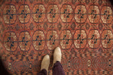 Antique Turkmen carpet detail, showing madder red Bokhara guls with low pile texture.