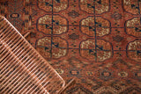 Antique Turkmen hand-knotted carpet's madder red Bokhara guls with unique plant motif border.