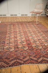 Corner of antique Turkmen carpet, unique pomegranate-motif end border and fringed edge.