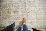 Overhead view of a distressed Sivas carpet, showcasing its ivory, beige tones and worn texture.