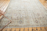 Distressed vintage Sivas carpet, its faded allover design in ivory, beige, and charcoal brown.
