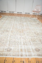 Textured lower border and field of a distressed vintage Sivas carpet with muted tones.