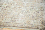 Distressed hand knotted Turkish Sivas carpet, showing faded curvilinear motifs in ivory, beige, and charcoal.